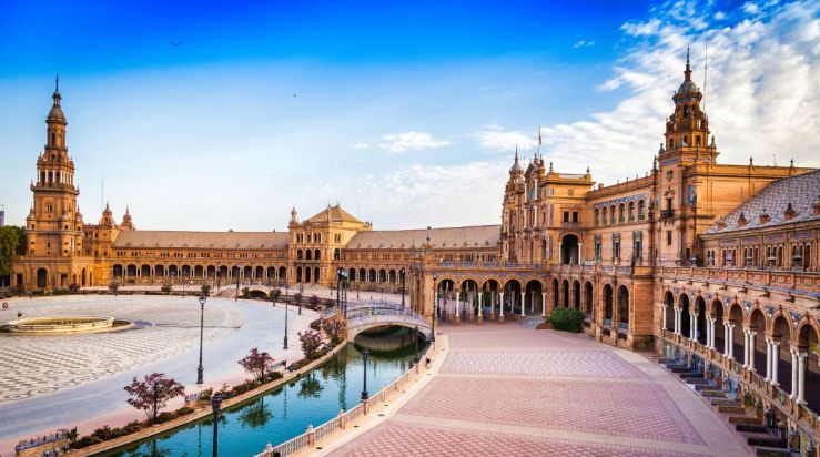 An image showing a city in Spain with buildings surrounding a river.
