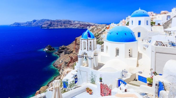 An image showing the famous blue and white architecture in Santorini, Greece. 
